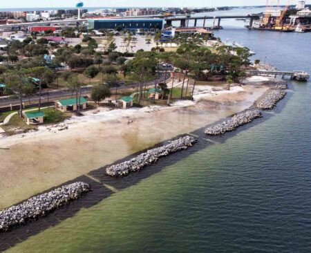 Aerial view of a living shoreline with offshore rock breakwaters along Choctawhatchee Bay at Ross Marler Park on Okaloosa Island.