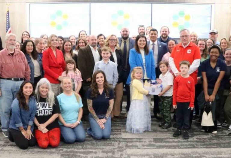 Brittany Young stands with family members, school staff, and Okaloosa County School District leaders after being named principal of Walker Elementary School.