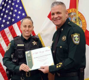 Off-duty deputy saves choking man at restaurant Deputy Michelle Spooneybarger receives a Life Saving Award from Sheriff Eric Aden during an Okaloosa County Sheriff’s Office ceremony.