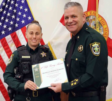 Off-duty deputy saves choking man at restaurant Deputy Michelle Spooneybarger receives a Life Saving Award from Sheriff Eric Aden during an Okaloosa County Sheriff’s Office ceremony.