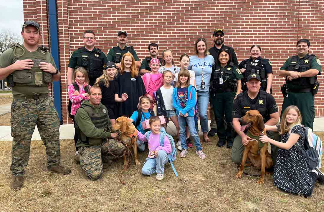 Plew Elementary students pose with deputies and K-9 units during High Five a Hero event in Niceville.