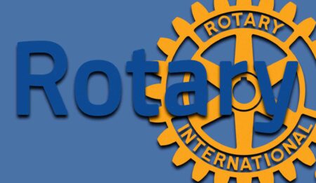 Rotary International logo with blue “Rotary” text over gold gear wheel