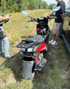 Black-and-red moped stopped by deputies during a Walton County traffic stop investigation