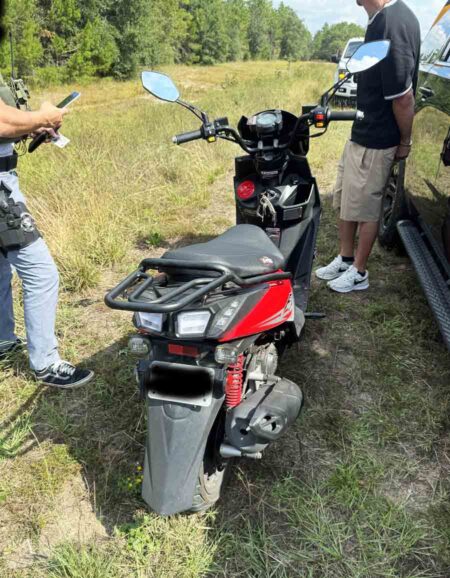 Black-and-red moped stopped by deputies during a Walton County traffic stop investigation