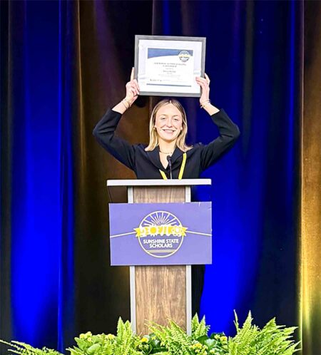 Niceville High School junior Emma Michel holds a Sunshine State Scholars certificate during the statewide conference in Orlando.