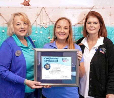 Anna Klepser holds a framed certificate recognizing 25 years of service with Eglin Federal Credit Union. She is with President/CEO Cathie Staton and Bluewater Bay Branch Manager Shannon Whitaker.