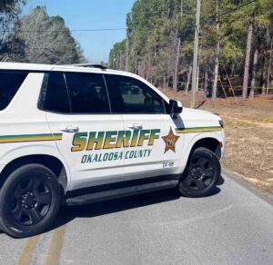 Okaloosa County Sheriff’s Office patrol SUV parked on a rural roadway during a homicide investigation near Crestview.