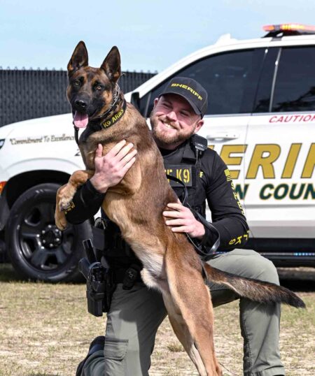 Walton County Sheriff’s Office K-9 Aries with handler posing in front of patrol vehicle