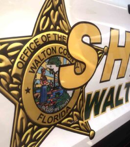 Walton High teacher arrested in student authority figure case Walton County Sheriff’s Office badge displayed on a patrol vehicle door.