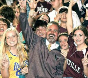 Niceville High School Principal Charlie Marello celebrates with students at a school sporting event