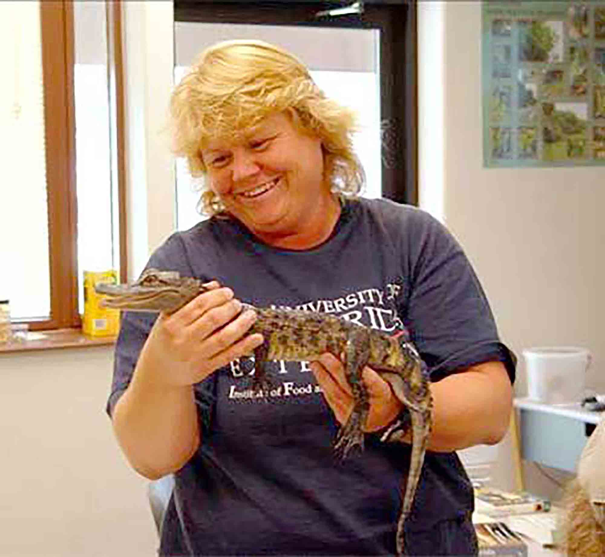 Sheila Dunning holds a young alligator during an educational demonstration