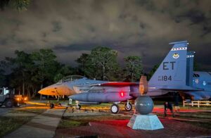 F-15E Strike Eagle is towed into position at the Air Force Armament Museum at night