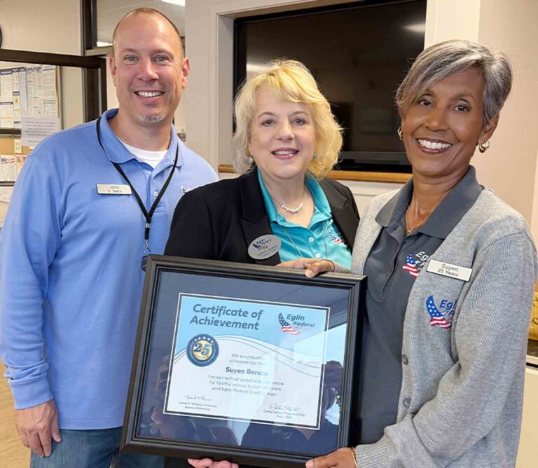 Eglin Federal Credit Union employee Suyen Berezo receives a 25-year service award alongside coworkers