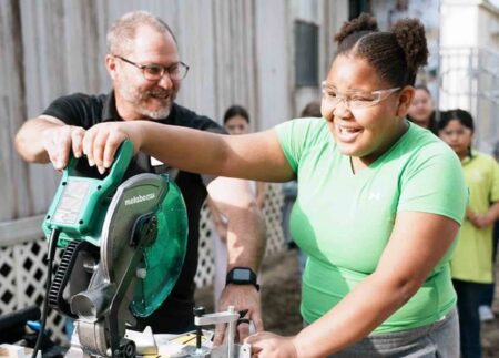 Kids build toolboxes, learn math in new OCSD program Elementary student uses a miter saw with guidance from an instructor during a hands-on math activity
