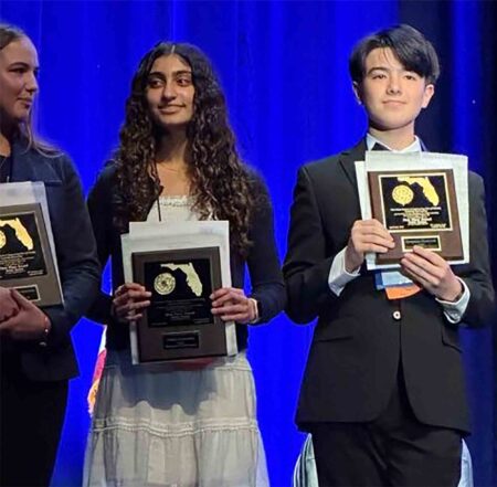 Students on stage holding awards at the State Science and Engineering Fair in Florida