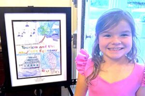 Destin kindergartner among six statewide art winners Destin Elementary School kindergartner Claire Grelle smiles beside her framed award-winning artwork during a student recognition event.