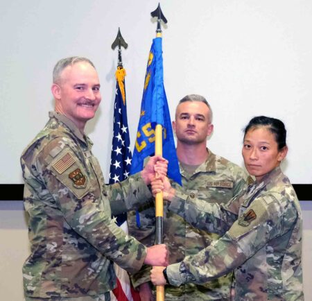 U.S. Air Force Col. Terry Hjerpe transfers the 505th Communications Squadron guidon during a change of command ceremony at Hurlburt Field as Lt. Col. Justin Raynor assumes command from outgoing commander Lt. Col. Crystal Lusardi on June 18, 2026.
