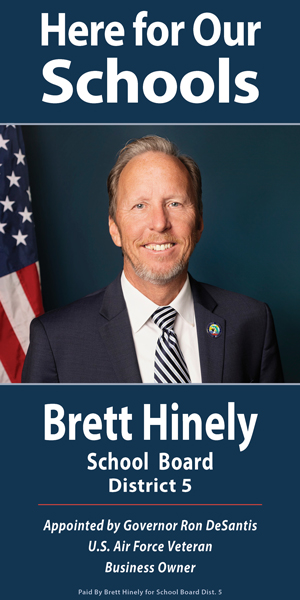 Digital campaign banner for Brett Hinely for Okaloosa County School Board District 5 featuring the slogan "Here for Our Schools" above a formal portrait with an American flag in the background.
