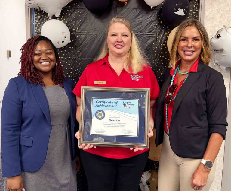 Eglin FCU employee honored for 25 years of service Eglin Federal Credit Union employees Nikki Manzie, Clasina Cox and Lesli Harding pose with a framed certificate recognizing Cox's 25 years of service during a celebration at the Eglin Air Force Base Branch.
