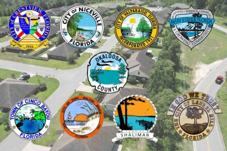 Okaloosa County and municipal seals displayed over an aerial view of a residential community.