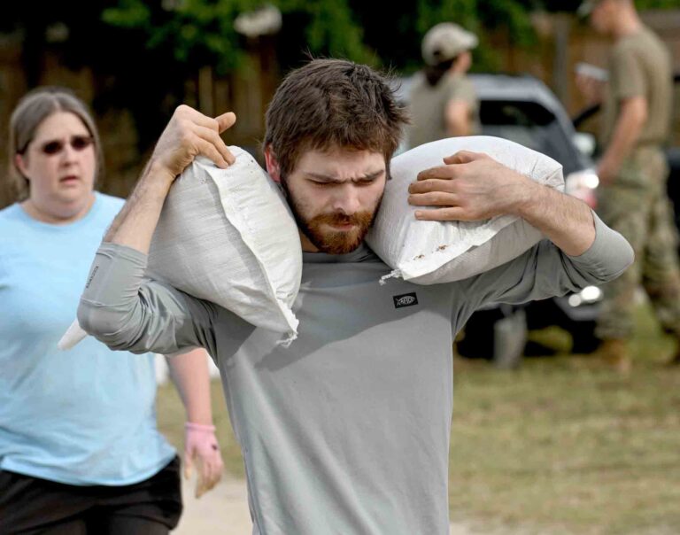 Okaloosa orders evacuations, opens shelters ahead of hurricane Man carries two sandbags over his shoulders as residents prepare for approaching hurricane conditions.